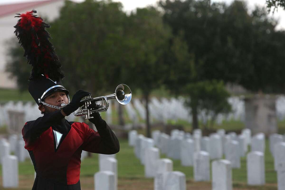Wagner High School student Edward Voyce plays TAPS to conclude the Gravesite Memorial for Lt. Col. Karen Wagner at Fort Sam Houston National Cemetery Sept. 11, 2014.