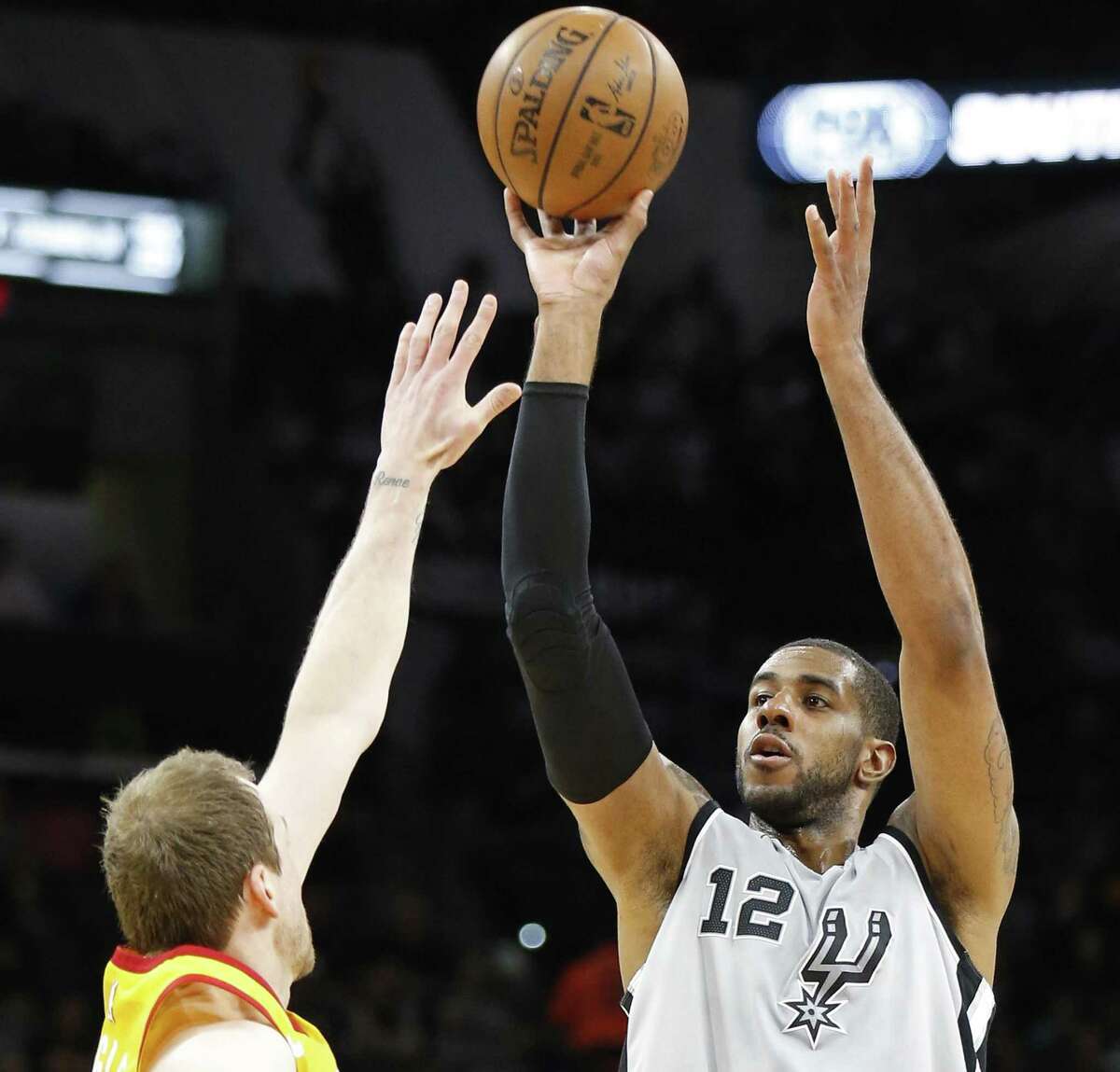 San Antonio Spurs' LaMarcus Aldridge shoots a 3-pointer over Utah Jazz's Joe Ingles during first half action Friday March 23, 2018 at the AT&T Center.