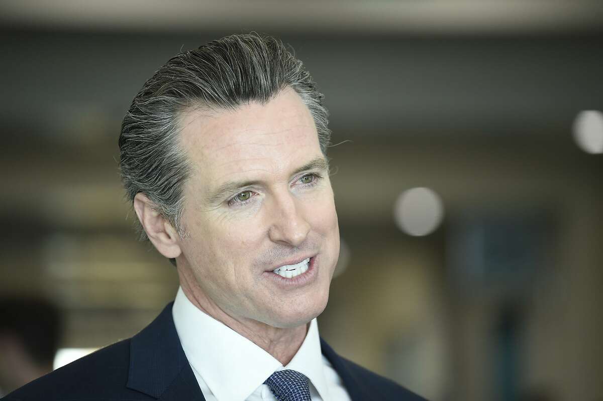 Democratic gubernatorial candidate Gavin Newsom speaks during an interview before a town hall meeting at the 2018 California Democrats State Convention Saturday, Feb. 24, 2018, in San Diego. (AP Photo/Denis Poroy)