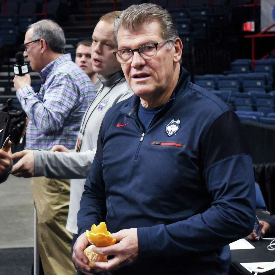 UConn head coach Geno Auriemma peels an orange as he speaks with reporters during their NCAA Women's Basketball regional practice at the Times Union Center Friday March 23, 2018 in Albany, NY.  (John Carl D'Annibale/Times Union) Photo: John Carl D'Annibale / 20043279A
