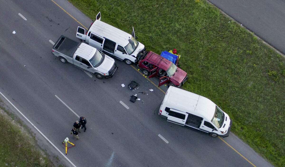 Officials investigate the scene where they say a bombing suspect blew himself up in his vehicle, off of Interstate 35 in Round Rock, Texas, Wednesday morning, March 21, 2018. The 24-year-old white man, named Mark Anthony Conditt, was a suspect in the series of bombings that have terrorized the city of Austin, Texas in recent days, the authorities said. He died in the blast early Wednesday, authorities said. (Jay Janner/Austin American-Statesman via The New York Times) -- AUSTIN CHRONICLE OUT, COMMUNITY IMPACT OUT, TV MUST CREDIT PHOTOGRAPHER AND STATESMAN.COM ON SCREEN, MAGS OUT, NEWSPAPERS ONLY ONLINE. Contact source for special permissions