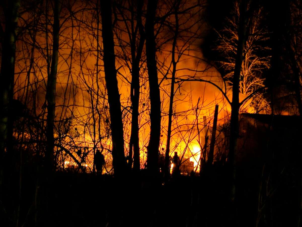A Grout Township property was engulfed in flames Thursday night in the 3000 block of West Howard Road, east of M-18. Seven area fire trucks responded along with two ambulances. (Tereasa Nims/for the Daily News)