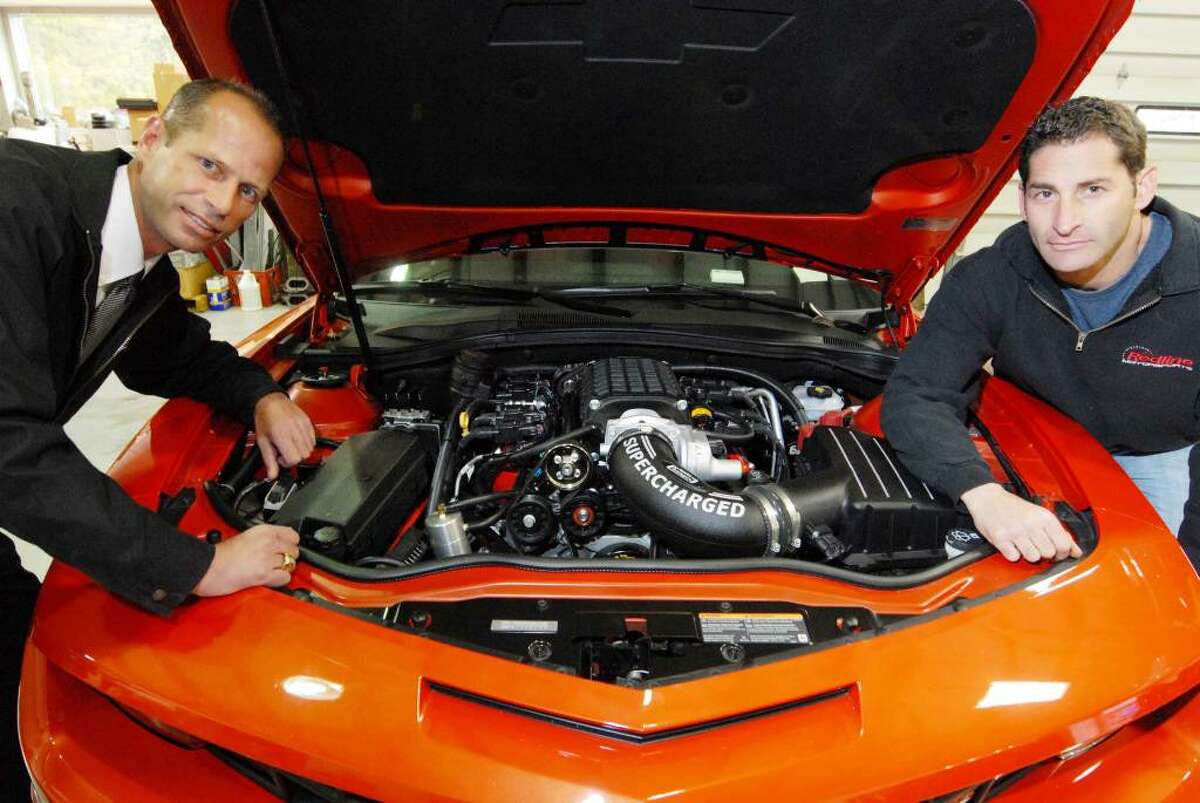 Dan Coulton ,left, and Howard Tanner of Redline Motorsports with a 2010 Camero in Rotterdam. (Michael P. Farrell / Times Union)