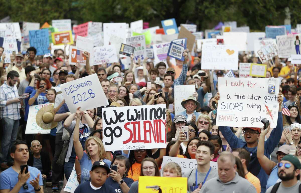 Protesters raise their signs as Mayor Sylvester Turner spoke to the crowd during the March for Our Lives protest and march starting at Tranquility Park, Saturday, March 24, 2018, in Houston. After the recent mass shooting at Stoneman Douglas, students of the school have organized a nationwide protest including Houston, TX to plea for a strengthening of gun laws. ( Karen Warren / Houston Chronicle )