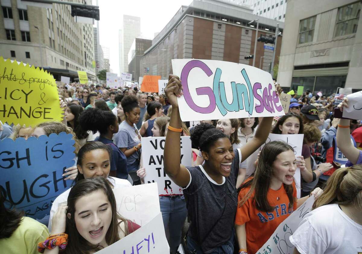 People participate in the March For Our Lives protest outside the office of Senator Ted Cruz on Travis St. in downtown Houston Saturday, March 24, 2018. ( Melissa Phillip / Houston Chronicle )