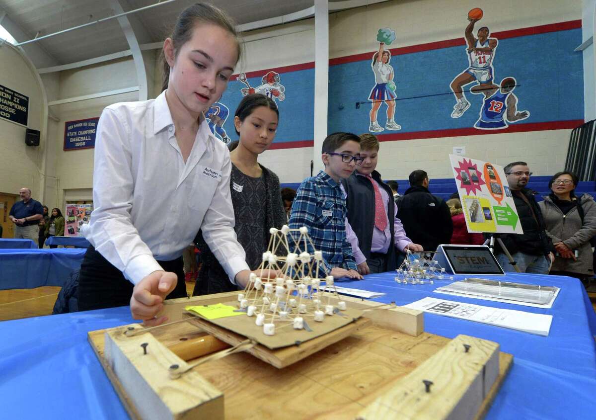 West Rocks Middle Schoole 7th grader Autumn Peterson and her classmates in Team Joe demonstrate their Earthquake resistant Marshmallow Tower during the citywide STEM Expo Saturday, March 24, 2018, at Brien McMahon High School in Norwalk, Conn. The second annual citywide event, which is themed ?“Innovation,?” focused on the ability of students to think, question, design, create, struggle, collaborate, try, solve, invent, reflect and learn.