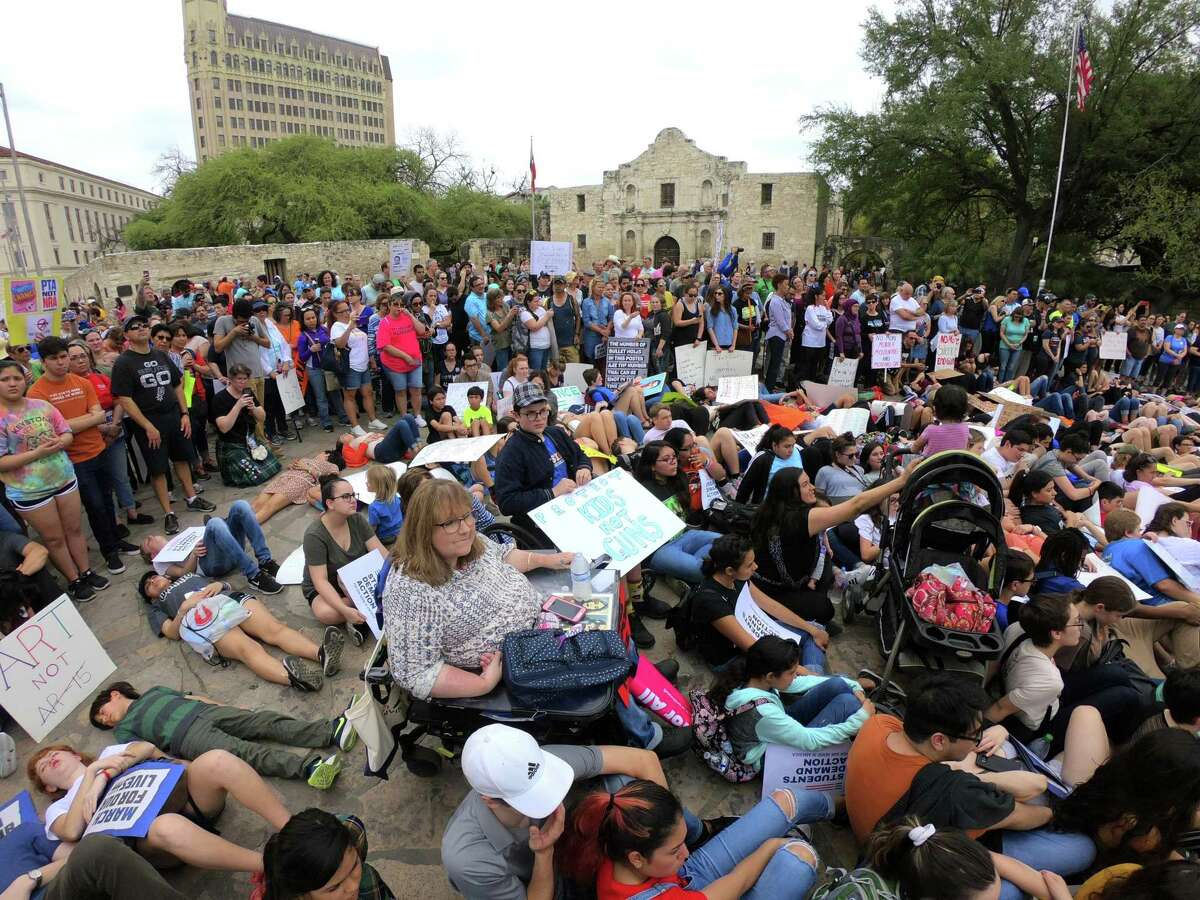 Students recline and sit in front of the Alamo in remembrance of students killed in school shootings during the March for Our Lives San Antonio on Saturday. The event was one of many such marches held across the nation, prompted by the school shootings at Stoneman Douglas High School in Parkland, Fla.