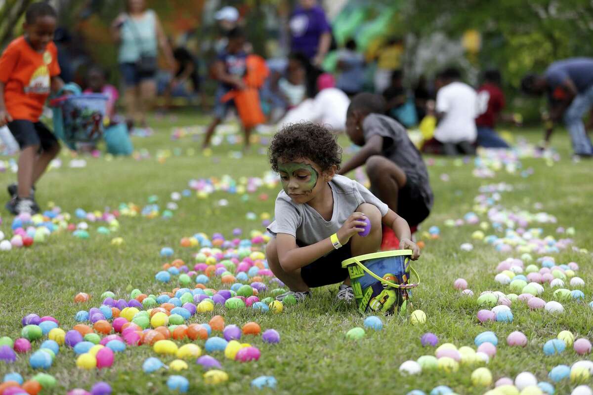 Joseph Diaz, 5, gathers Easter eggs after a helicopter dropped eggs during the 2018 Fifth Ward Lyons Avenue Renaissance Festival, on Lyons Avenue, Saturday, March 24, 2018, in Houston. Organizers include Houston City Councilman Jerry Davis and non-profit organization, the Fifth Ward Community Redevelopment Corporation (FWCRC) ( Karen Warren / Houston Chronicle )