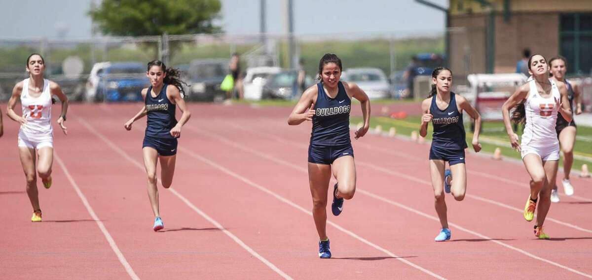 Liliana Perez is surrounded by United twins Andrea and Alexandra Sanabria and Alexander twins Alicia and Ellese Treviño in the 400-meter dash at the Laredo city track meet.