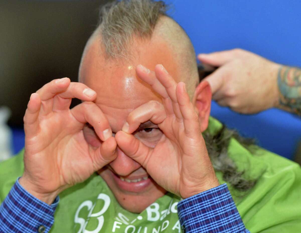 People shave their heads at The TeamBrent St. Baldrick’s Foundation head shaving celebration at the Westport Family YMCA on Sunday March 25, 2018, in Westport Conn. This is the 14th year of the event and they have raised over four million dollars for childhood cancer research for the St. Badlrick’s Foundation.
