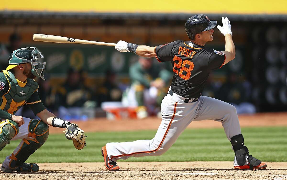 San Francisco Giants' Buster Posey swings for a two run double off Oakland Athletics' Daniel Gossett during the third inning of an exhibition baseball game on Sunday, March 25, 2018 in Oakland, Calif. (AP Photo/Ben Margot)
