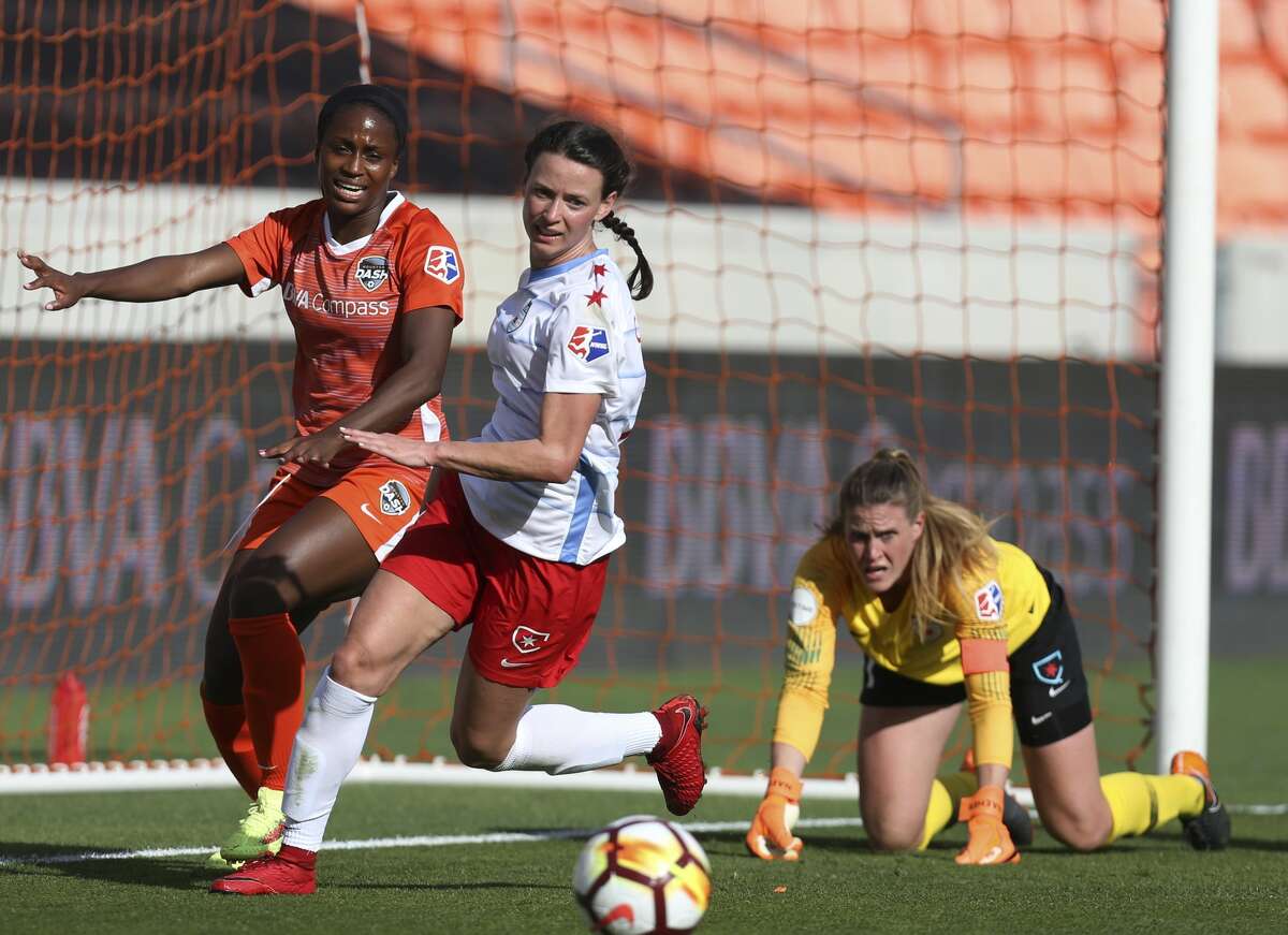 Houston Dash forward Nichelle Prince (14) and Chicago Red Stars midfielder Taylor Comeau (7) go after the ball after Chicago Red Stars goalkeeper Alyssa Naeher (1) palms the ball away from the goal during the second half of the season opener NWSL game at BBVA Stadium on Sunday, March 25, 2018, in Houston. The Houston Dash and the Chicago Red Stars tied at 1-1. ( Yi-Chin Lee / Houston Chronicle )
