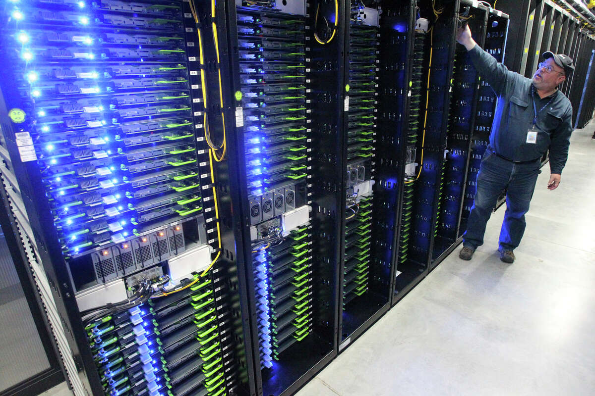 FILE - In this Oct. 15, 2013, file photo, Chuck Goolsbee, site director for Facebook's Prineville data centers, shows the computer servers that store users' photos and other data, at the Facebook site in Prineville, Ore. Facebook frequently defends its data collection and sharing activities by noting that it's adhering to a privacy policy it shares with users. 