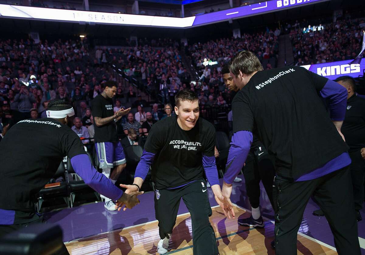 Sacramento Kings guard Bogdan Bogdanovic (8) and teammates wear T-shirts bearing the name of Stephon Clark during a game at Golden 1 Center on Sunday March 25, 2018 in Sacramento, Calif. The Kings and Celtics wore shirts bearing the name of the unarmed man, Stephon Clark, who was killed by Sacramento police. The black warm-up shirts have "Accountability. We are One" on the front and "Stephon Clark" on the back. (Paul Kitagaki Jr./Sacramento Bee/TNS)