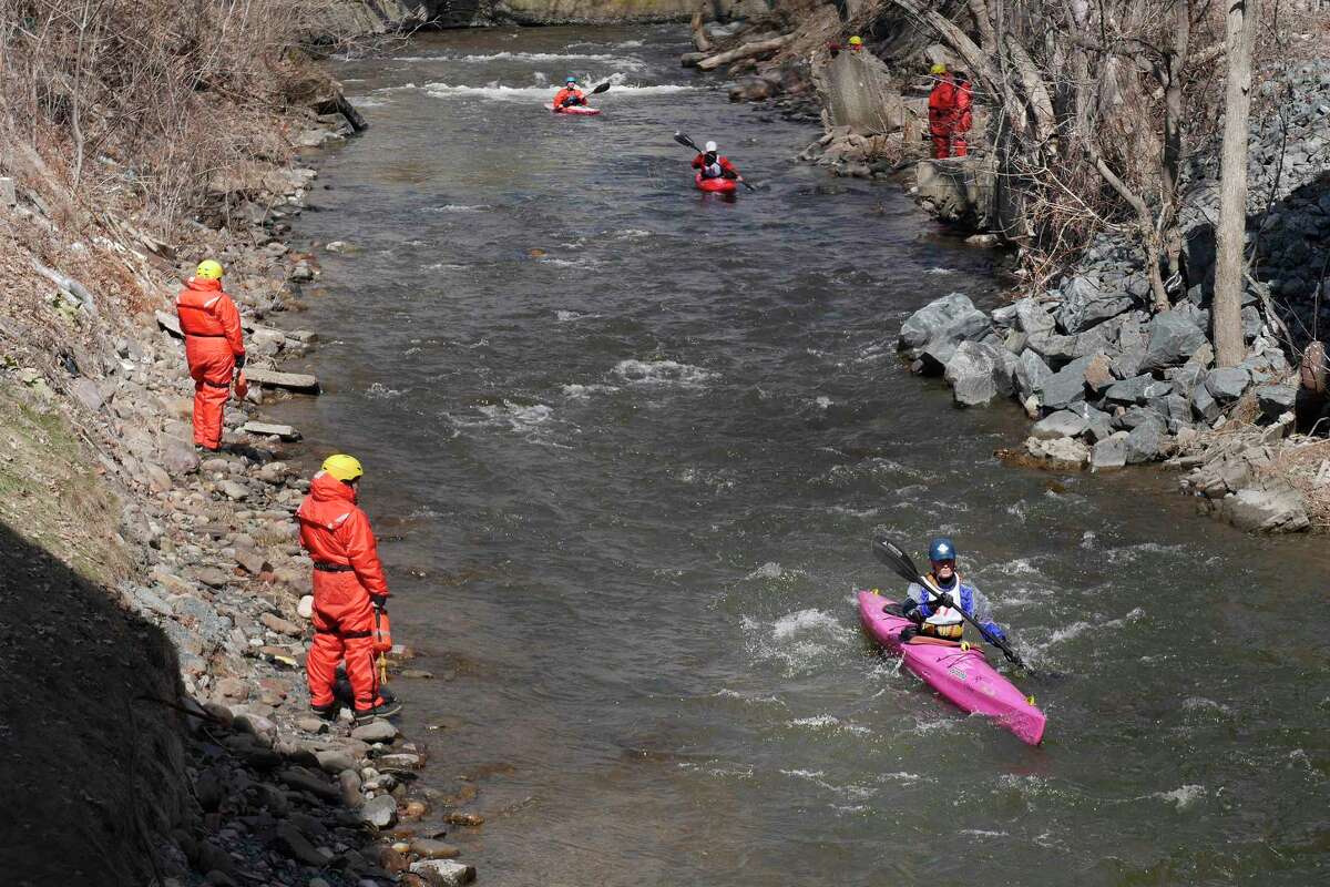 Rescue personnel stand on the banks as kayakers make their way along the course during the Tenandeho White Water Derby on Sunday, March 25, 2018, in Mechanicville, N.Y. (Paul Buckowski/Times Union)