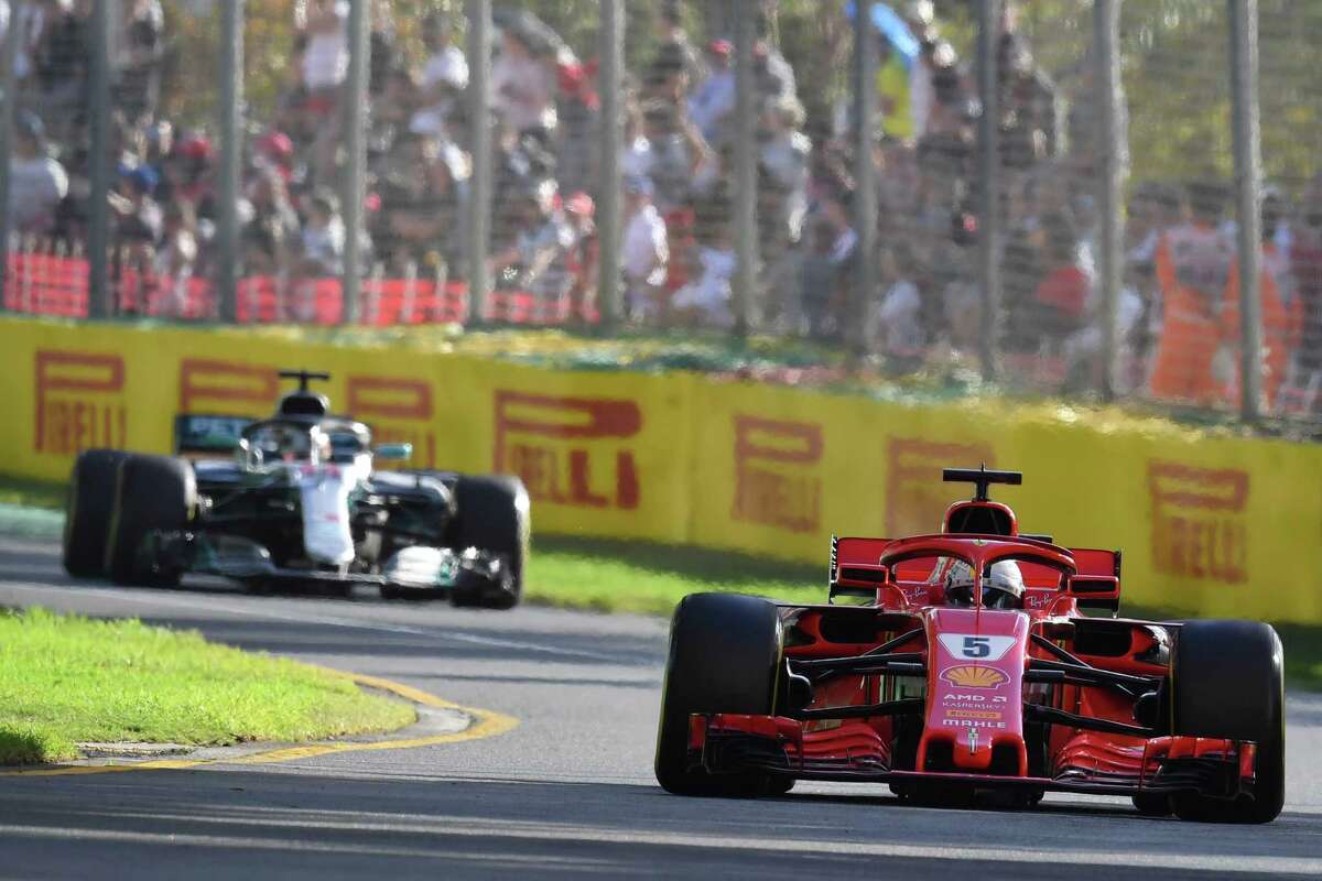 Ferrari's German driver Sebastian Vettel (R) leads Mercedes' British driver Lewis Hamilton during the Formula One Australian Grand Prix in Melbourne on March 25, 2018. / AFP PHOTO / Paul Crock / -- IMAGE RESTRICTED TO EDITORIAL USE - STRICTLY NO COMMERCIAL USE --PAUL CROCK/AFP/Getty Images