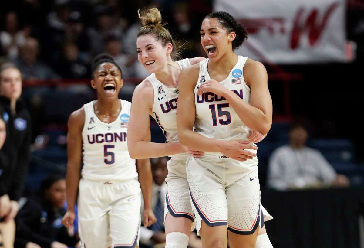 Connecticut's Crystal Dangerfield (5) and Katie Lou Samuelson (33) celebrate a 3-point basket by Gabby Williams (15) during the first half in a regional semifinal against Duke at the NCAA women's college basketball tournament Saturday, March 24, 2018, in Albany, N.Y. (AP Photo/Frank Franklin II)