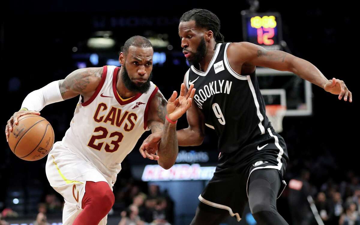 NEW YORK, NY - MARCH 25: LeBron James #23 of the Cleveland Cavaliers dribbles to the basket against DeMarre Carroll #9 of the Brooklyn Nets in the third quarter during their game at Barclays Center on March 25, 2018 in the Brooklyn borough of New York City. NOTE TO USER: User expressly acknowledges and agrees that, by downloading and or using this photograph, User is consenting to the terms and conditions of the Getty Images License Agreement. (Photo by Abbie Parr/Getty Images)