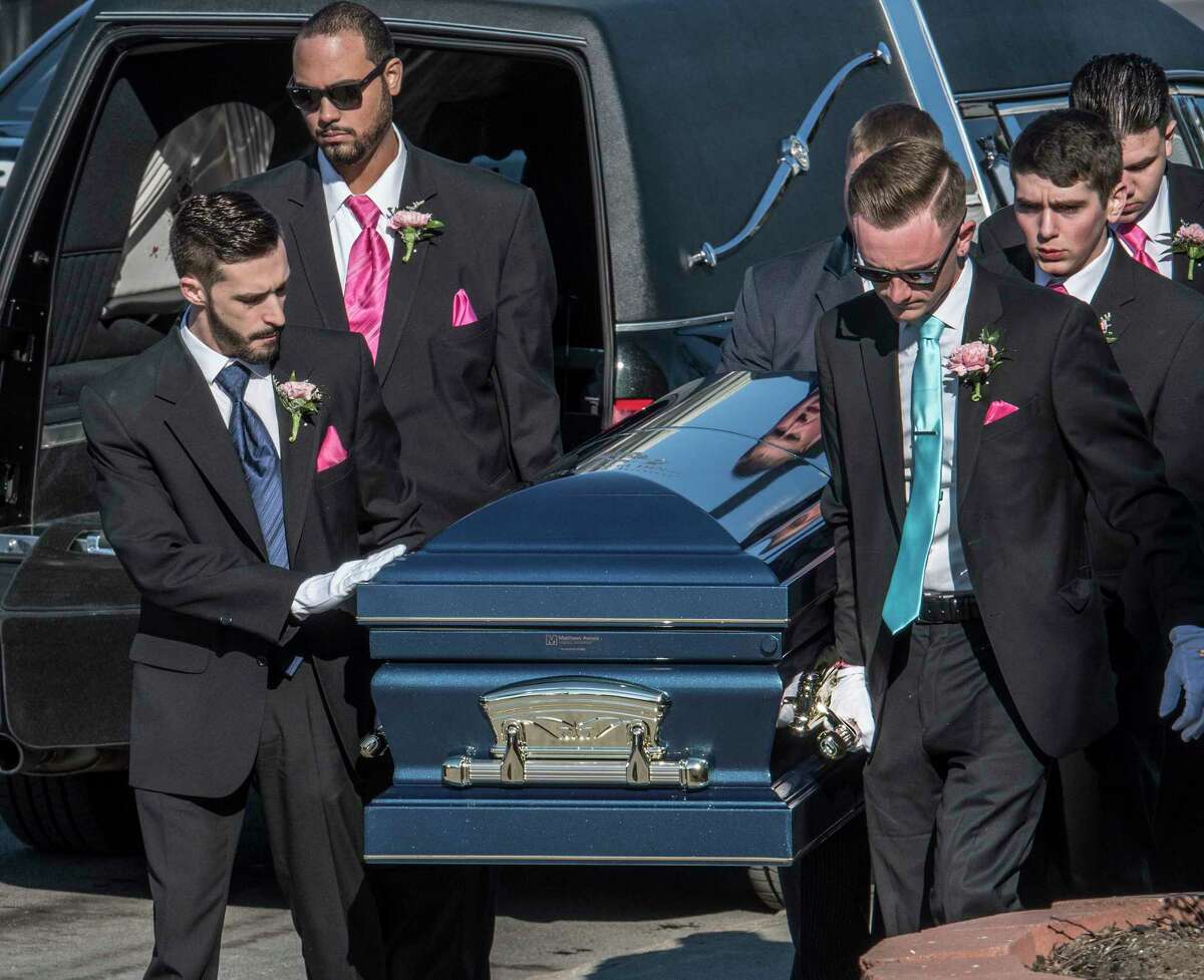Michael DiNovo, Niko's brother pat the casket as he enters Blessed Sacrament Church in Albany, N.Y. Monday March 16, 2018 for the his brother's funeral after he recently succumbed to injuries he received in a fiery crash in October of 2016. (Skip Dickstein/Times Union)