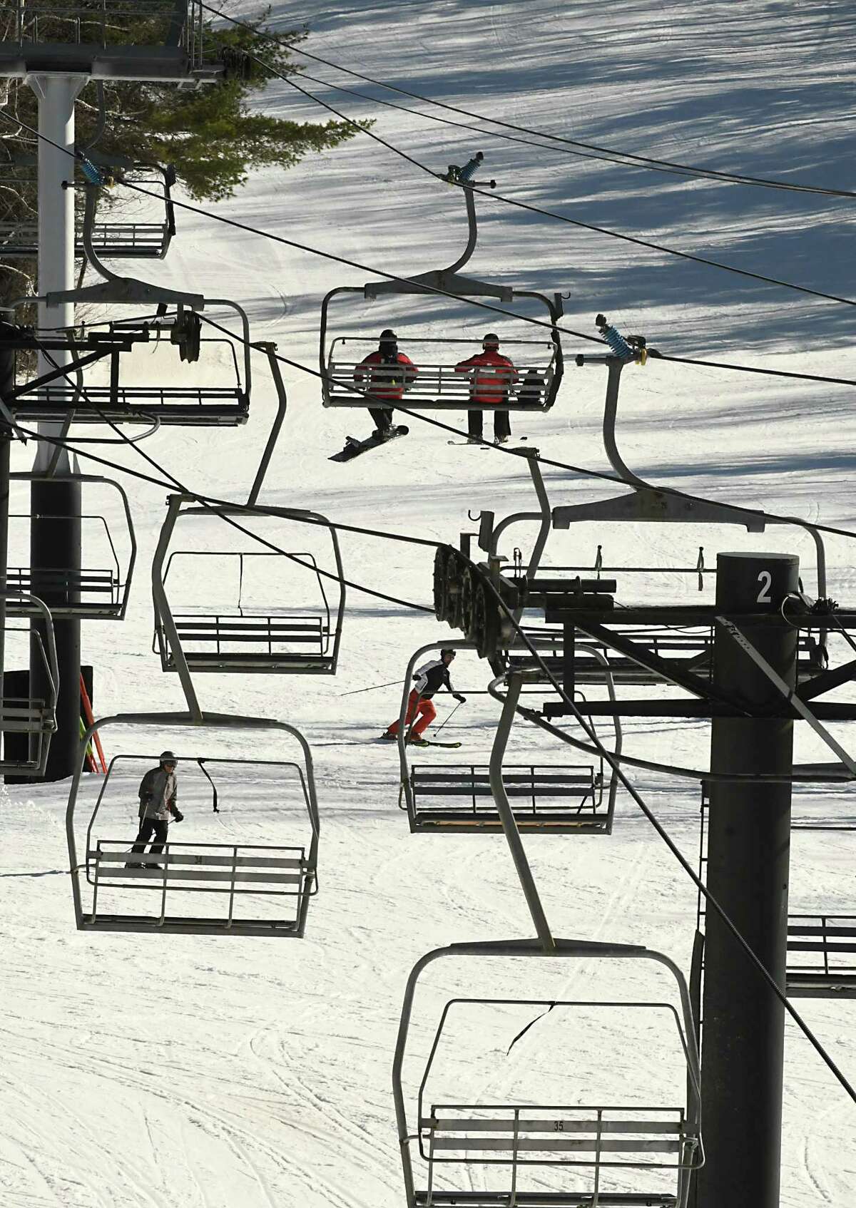 Skiers take the chair lift to the top of the mountain as others make their way down the slope at Jiminy Peak Mountain Resort on Monday, March 26, 2018 in Hancock, Mass. (Lori Van Buren/Times Union)