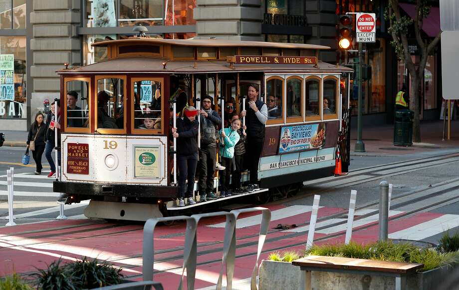 The Schmidgall family, (center) a party of seven visiting from Florida, purchased 6 adult fares, only one child was under 5 years old, to ride the world famous cable cars along the Powell st. line in San Francisco, Calif. on Mon. Mar. 26, 2018.
below: Families ride the world famous cable cars along the Powell st. line in San Francisco, Calif. on Mon. Mar. 26, 2018. Photo: Michael Macor, The Chronicle