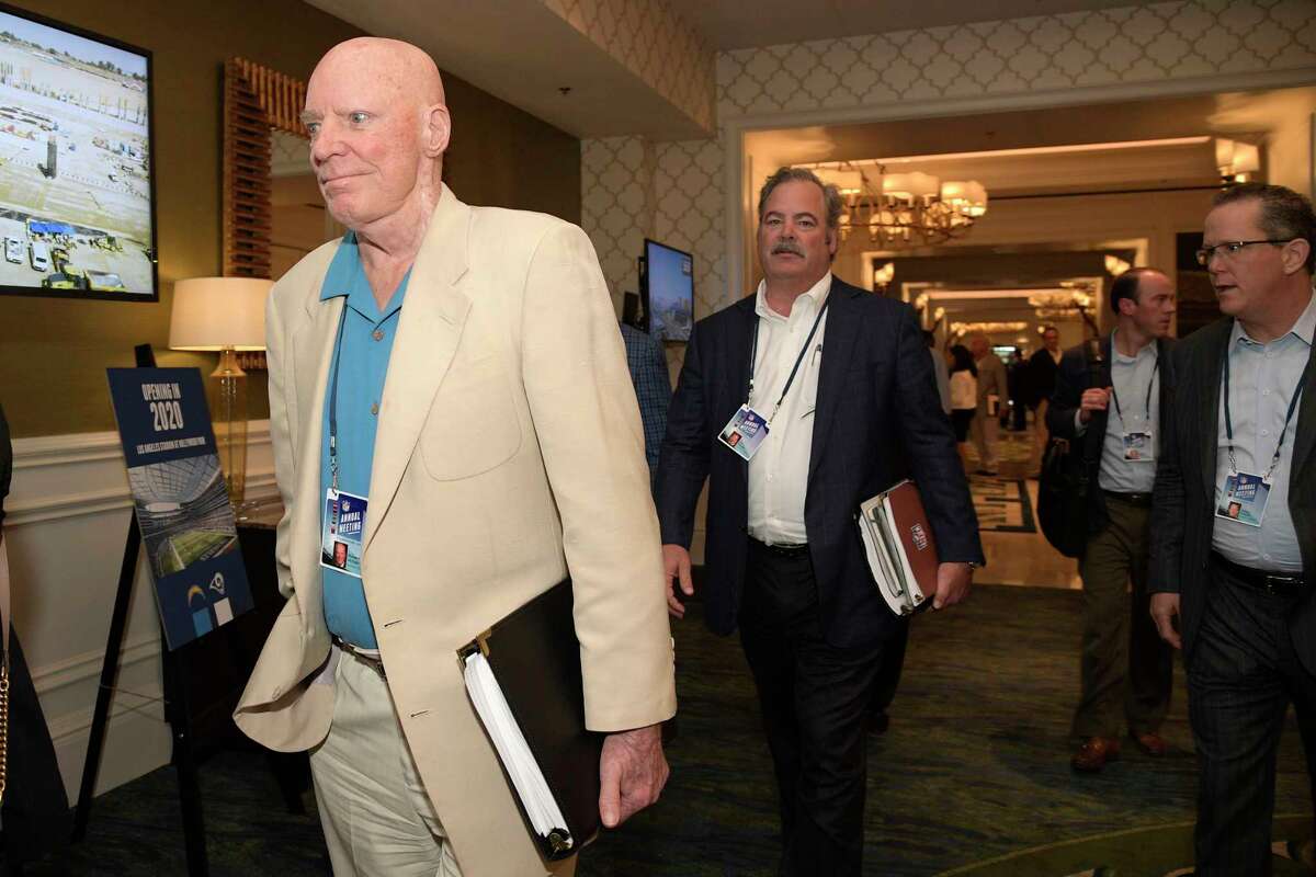 Houston Texans owner Bob McNair, left, and vice chairman Cal McNair, center, leave a conference room during the NFL owners meetings, Monday, March 26, 2018 in Orlando, Fla. (Phelan M. Ebenhack/AP Images for NFL)