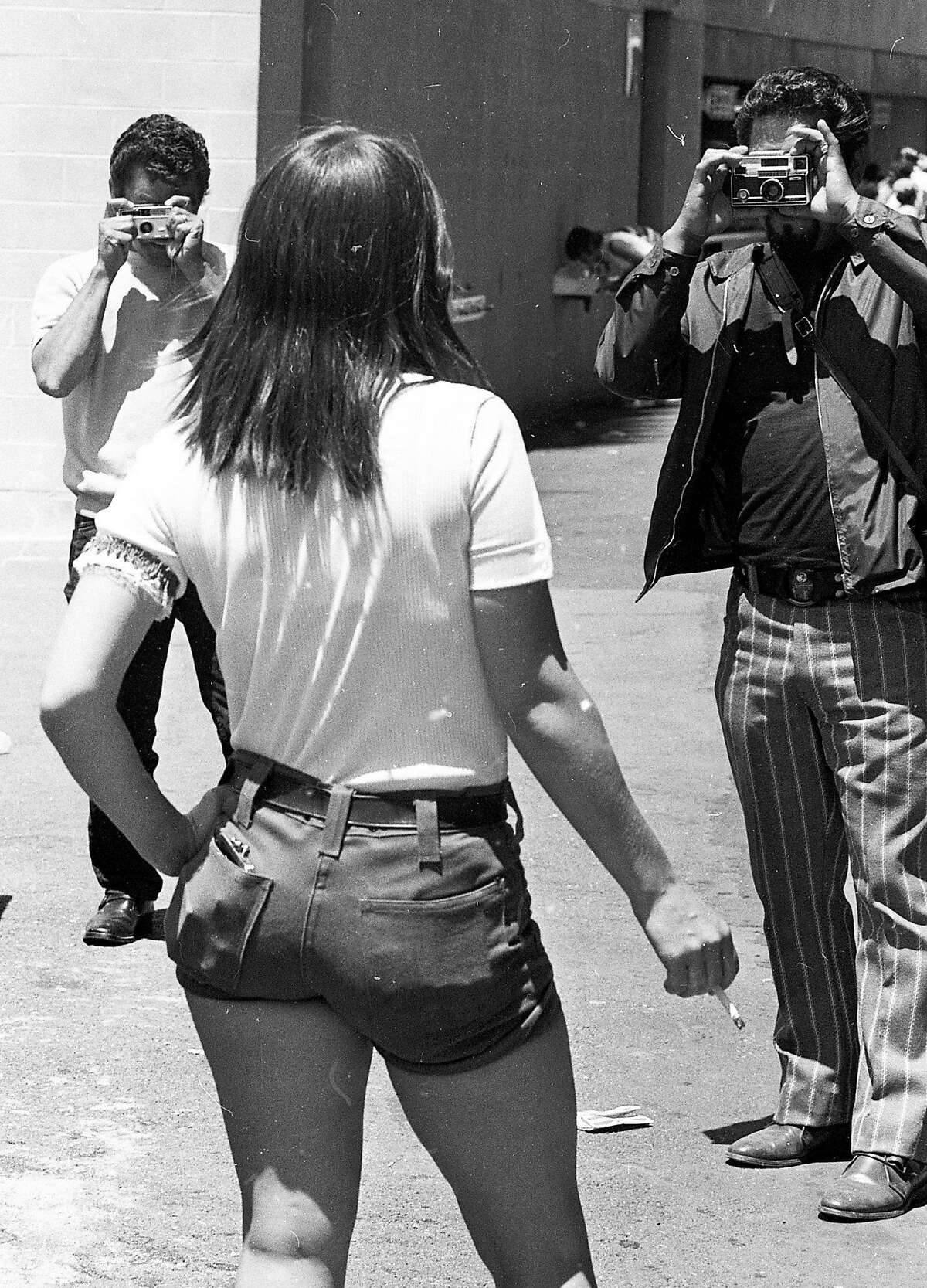 June 27, 1971: Male fans use their free cameras on "Hot Pants Day" at the Oakland Coliseum - a 1971 A's promotion where women in short tight shorts were given free tickets.