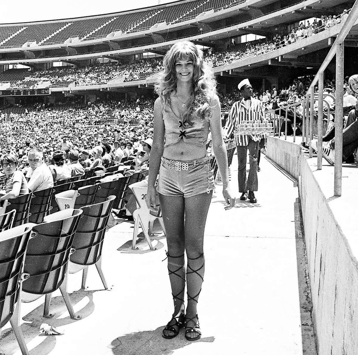 June 27, 1971: A woman walks through Oakland Coliseum during "Hot Pants Day" at the ballpark - a 1971 A's promotion where women in short tight shorts were given free tickets.