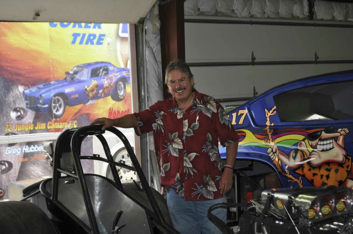 Henry M. Gutierrez Jr., who was killed Dec. 24, 2015, poses here with “funny cars,” drag racers that usually have fiberglass bodies over a custom-built frame. He owned three of the cars, which competed in the national drag racing circuit, his family said.