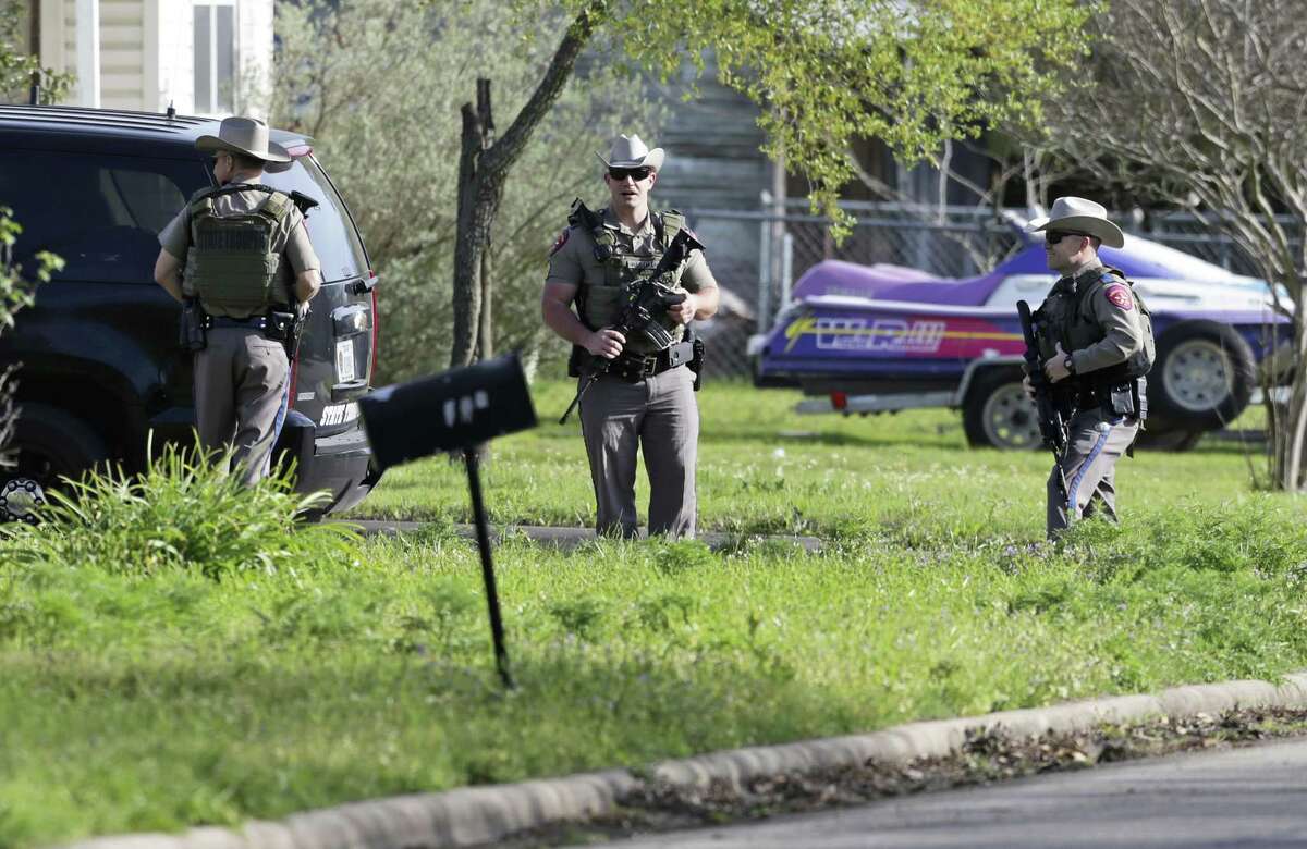 Law enforcement officers secure the neighborhood at the scene of Walnut and 2nd Street in Pflugerville, Texas, on Wednesday, March 21, 2018 where Austin, Texas bombing suspect Mark Anthony Conditt lived. As a SWAT team closed in, the suspected bomber whose deadly explosives terrorized Austin for three weeks used one of his own devices to blow himself up early Wednesday. (Tom Reel/The San Antonio Express-News via AP)