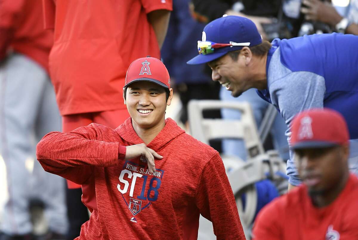 Angeles Angels' Shohei Ohtani, left, of Japan, talks with Los Angeles  Dodgers' Kenta Maeda, right, of Japan, as he stretches prior to a preseason  baseball game Monday, March 26, 2018, in Los