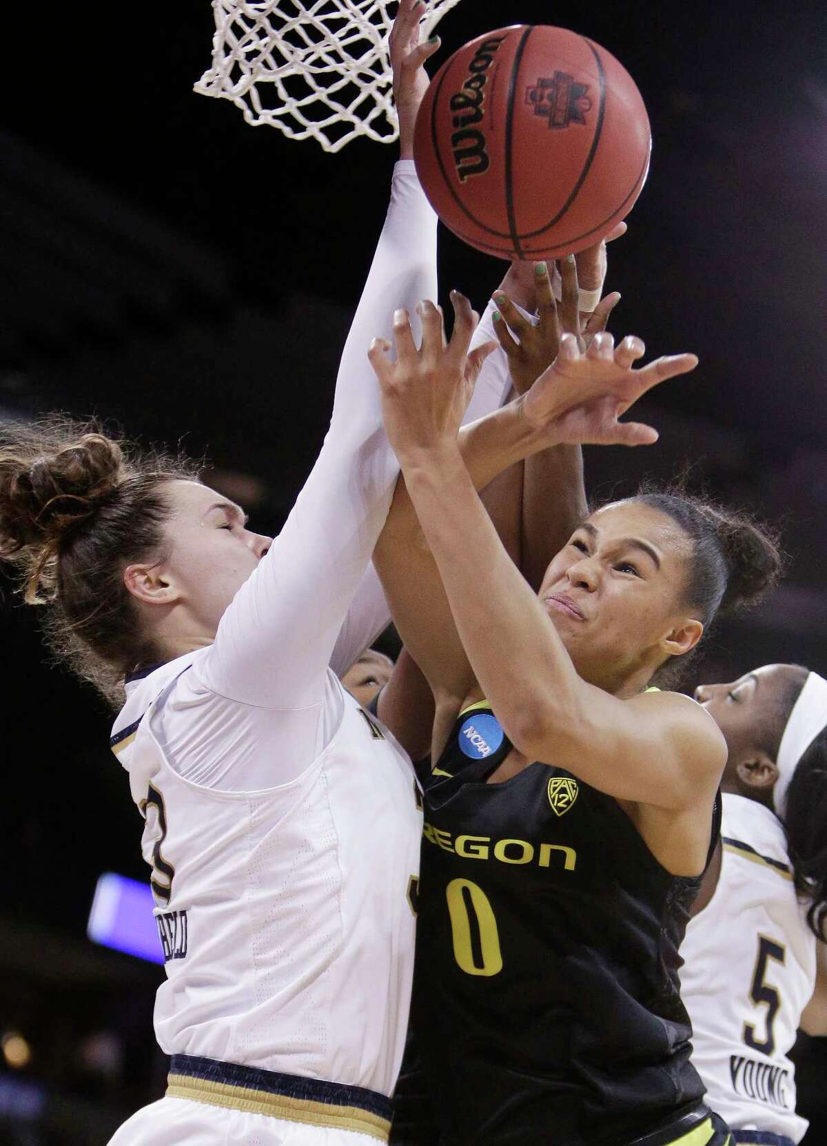 Oregon forward Satou Sabally (0) and Notre Dame forward Kathryn Westbeld go after a rebound during the first half in a regional final at the NCAA women's college basketball tournament, Monday, March 26, 2018, Spokane, Wash. (AP Photo/Young Kwak)