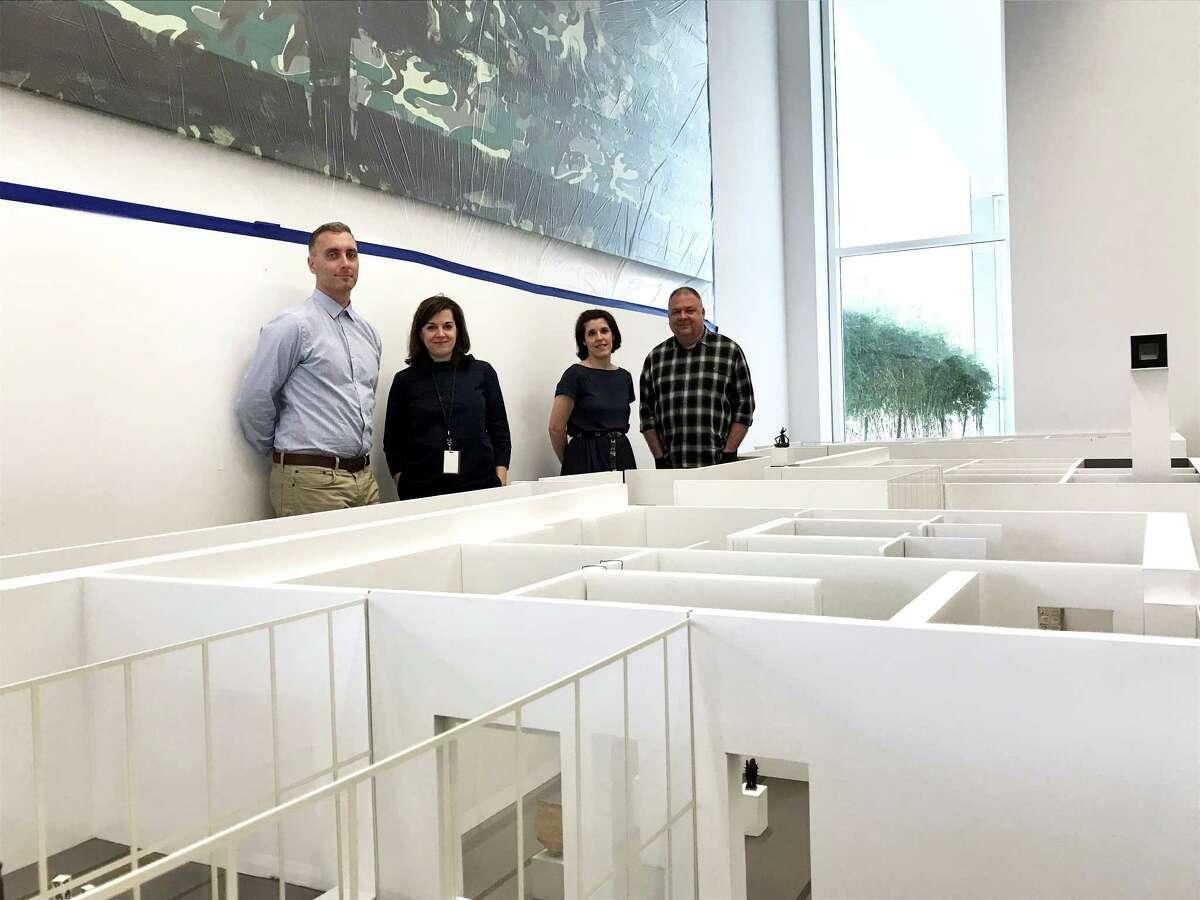 Menil Collection curators Paul Davis, from left, Michelle White and Clare Elliott and exhibition designer Brooke Stroud on Feb. 28 in the museum's model room, where they are planning a major redesign of gallery spaces