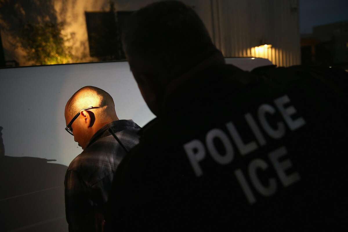 NORTHRIDGE, CA - OCTOBER 14: A man is detained by Immigration and Customs Enforcement (ICE), agents early on October 14, 2015 in Los Angeles, California. ICE agents said the undocumented immigrant was a convicted criminal and gang member who had previously been deported to Mexico and would be again. ICE builds deportation cases against thousands of undocumented immigrants, most of whom, they say, have criminal records. The number of ICE detentions and deportations from California has dropped since the state passed the Trust Act in October 2013, which set limits on California law enforcement cooperation with federal immigration authorities. (Photo by John Moore/Getty Images)