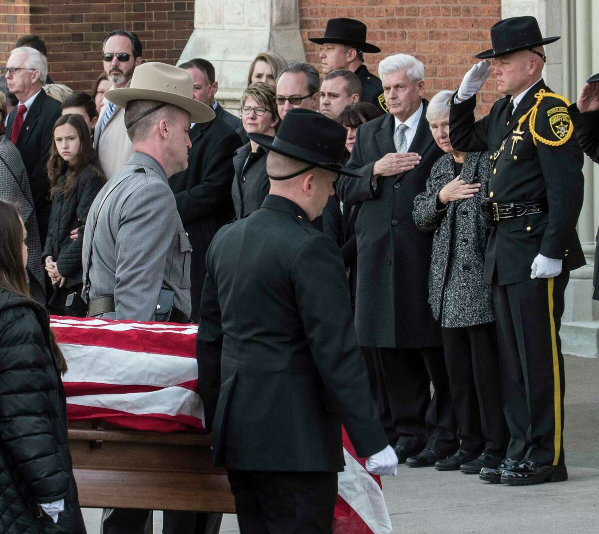 Pall bearers carry the casket carrying the remains of former Albany County Sheriff past his wife, Pat, second from right, to St. Mary's Church before his funeral ceremony Tuesday March 27, 2018 in Albany, N.Y. (Skip Dickstein/Times Union)
