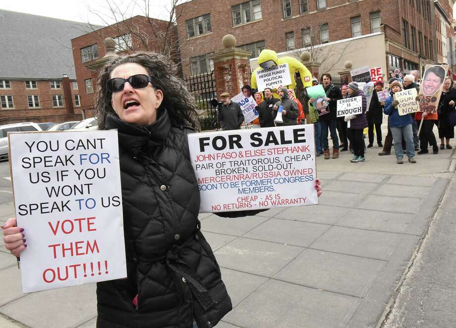 Nancy Eckert of Ravena, left, stands will other protestors outside a fundraiser for John Faso and Elise Stefanik at the Fort Orange Club on Tuesday, March 27, 2018 in Albany, N.Y. (Lori Van Buren/Times Union) Photo: Lori Van Buren, Albany Times Union / 20043308A	