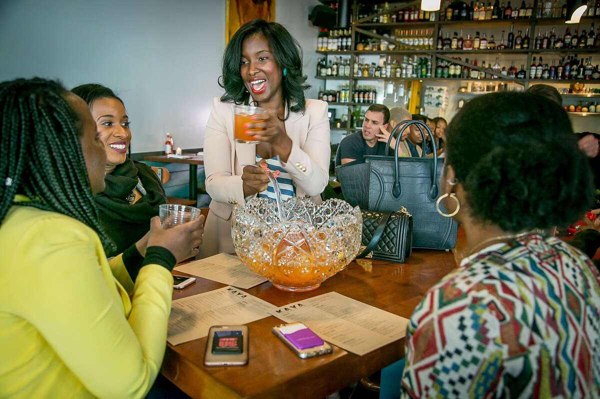 Safiya Jihan pours drinks from a punch bowl for her friends at Kaya in San Francisco, Calif. on March 24th, 2018.