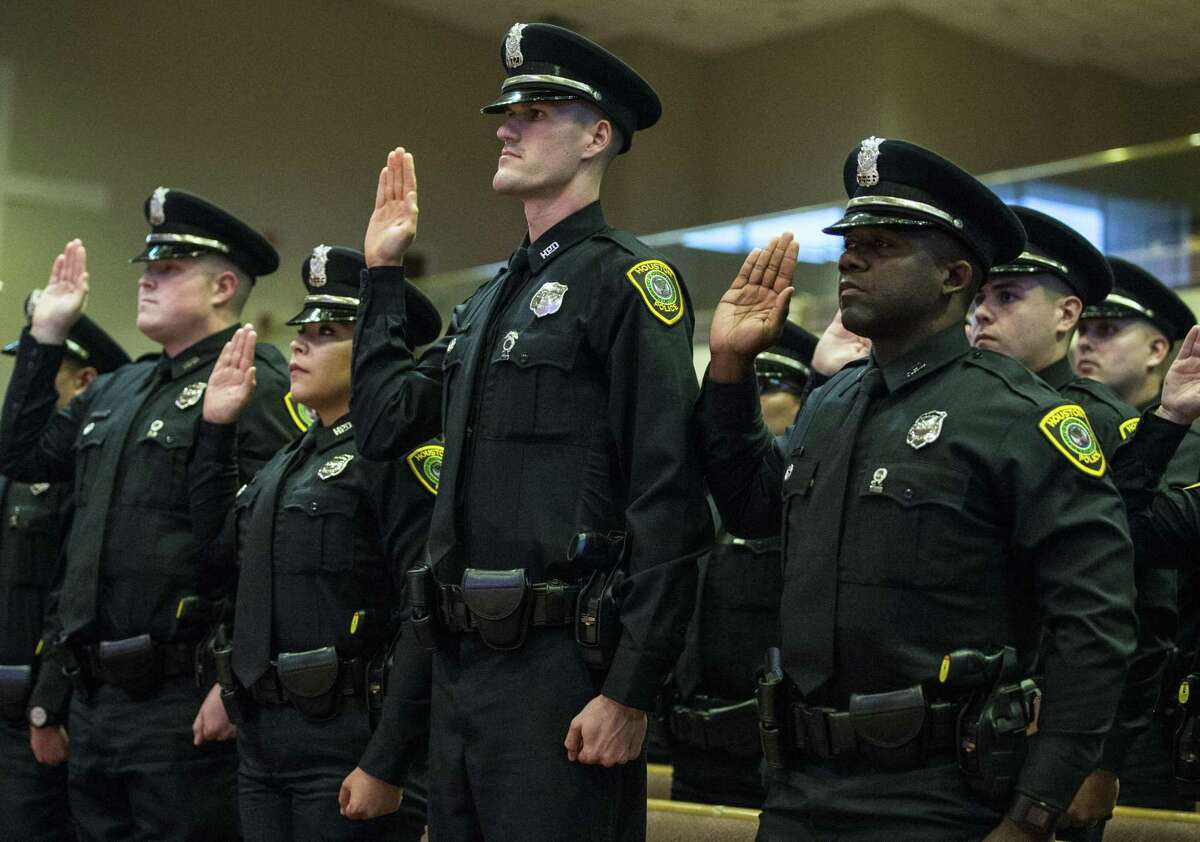 New Houston police officers are sworn in during the graduation ceremony of HPD Cadet Class 232 at Greater Grace Outreach Church in Houston on Oct. 2, 2017.