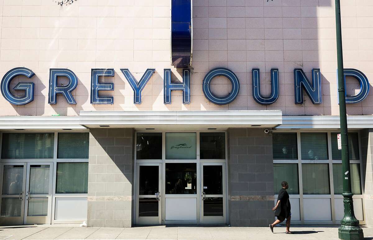 A woman walks by the main entrance of the Greyhound bus station Tuesday, March 27, 2018 in Oakland, Calif.