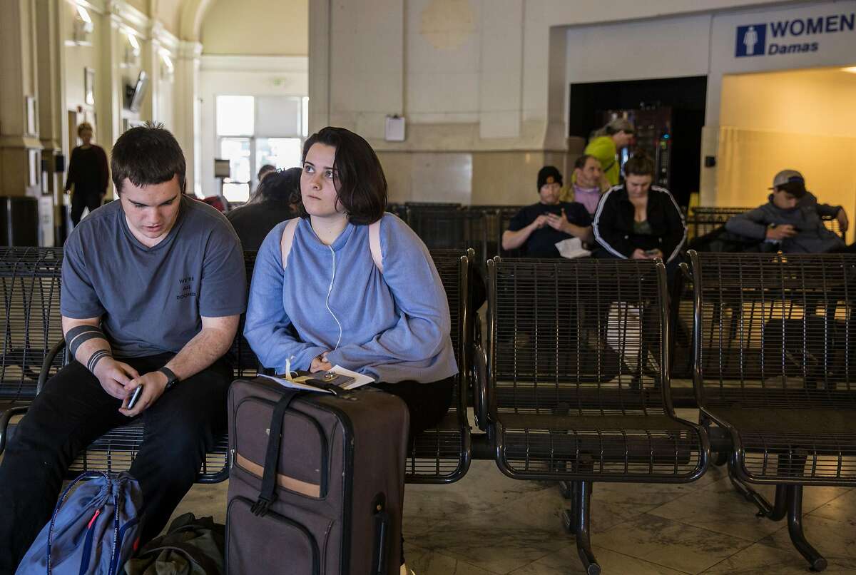 Kaamryn Bausrsfeld, 19, of Santa Barbara sits with her boyfriend after arriving at the Greyhound bus station Tuesday, March 27, 2018 in Oakland, Calif. on her way to San Francisco, Calif.