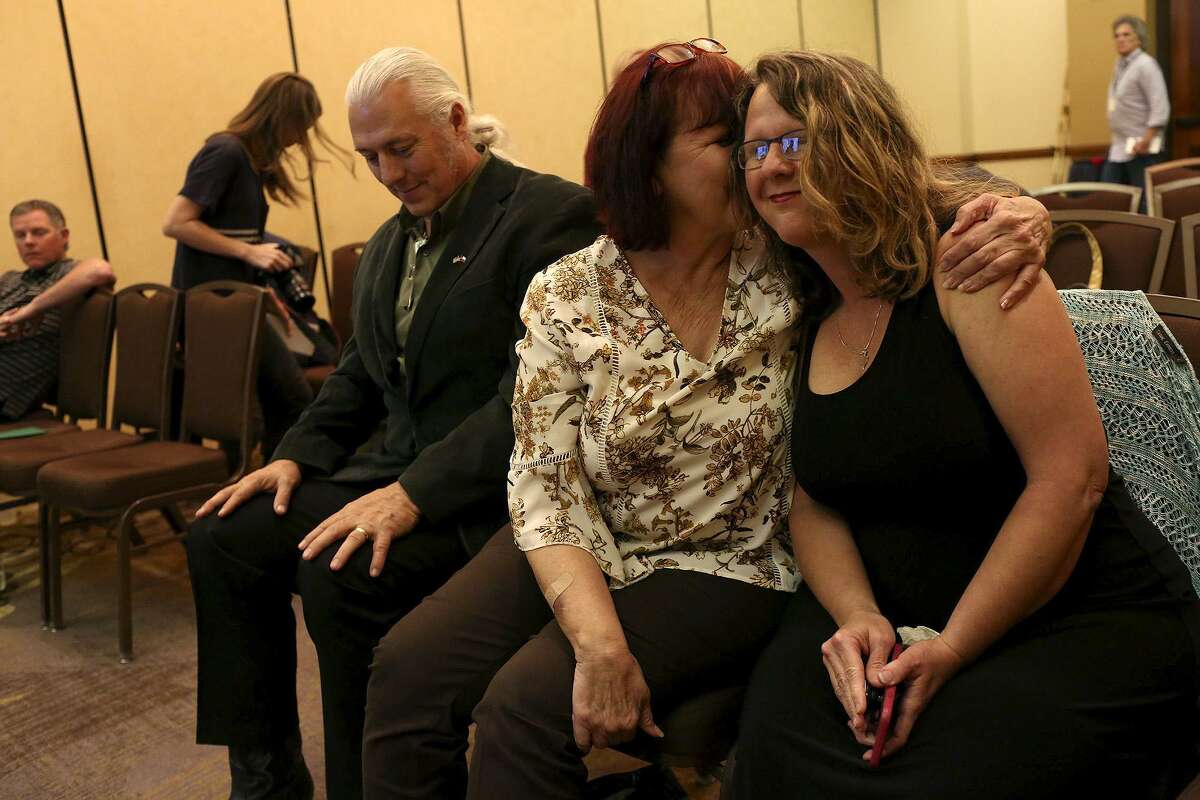 Sherri Pomeroy is embraced by her sister, Sylvia Timmons, at the conclusion of the press conference announcing the new building plans for First Baptist Church of Sutherland Springs at the Hilton San Antonio Airport on Tuesday, March 27, 2018. At left is Mark Collins.