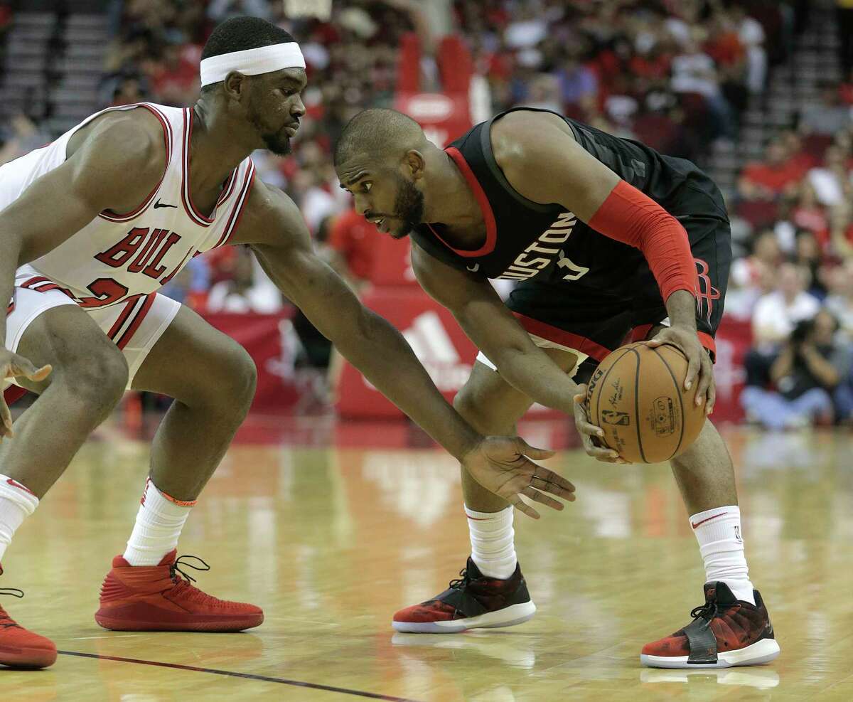 Houston Rockets guard Chris Paul (3) sizes up Chicago Bulls forward Noah Vonleh (30) in the second half at the Toyota Center on Tuesday, March 27, 2018, in Houston. Rockets won the game 118-86.