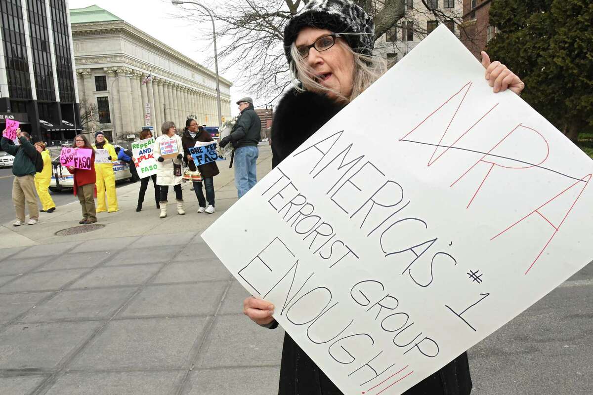 Barbara Dowdell of Halfmoon stands will other protestors outside a fundraiser for John Faso and Elise Stefanik at the Fort Orange Club on Tuesday, March 27, 2018 in Albany, N.Y. (Lori Van Buren/Times Union)