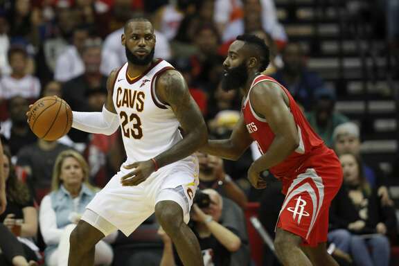HOUSTON, TX - NOVEMBER 09:  LeBron James #23 of the Cleveland Cavaliers controls the ball against James Harden #13 of the Houston Rockets in the first half at Toyota Center on November 09, 2017 in Houston, Texas.  NOTE TO USER: User expressly acknowledges and agrees that, by downloading and or using this photograph, User is consenting to the terms and conditions of the Getty Images License Agreement.  (Photo by Tim Warner/Getty Images)