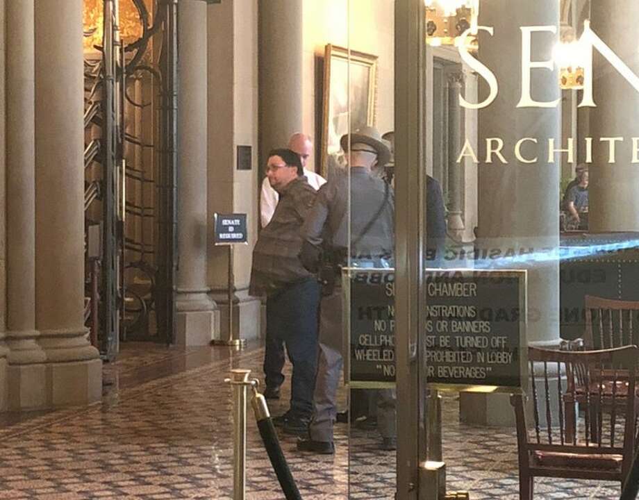 New York Daily News reporter Ken Lovett is handcuffed by State Police in the state Senate lobby on Wednesday, March 28, 2018. [Photo by Sean Ewart) Photo: Sean Ewart