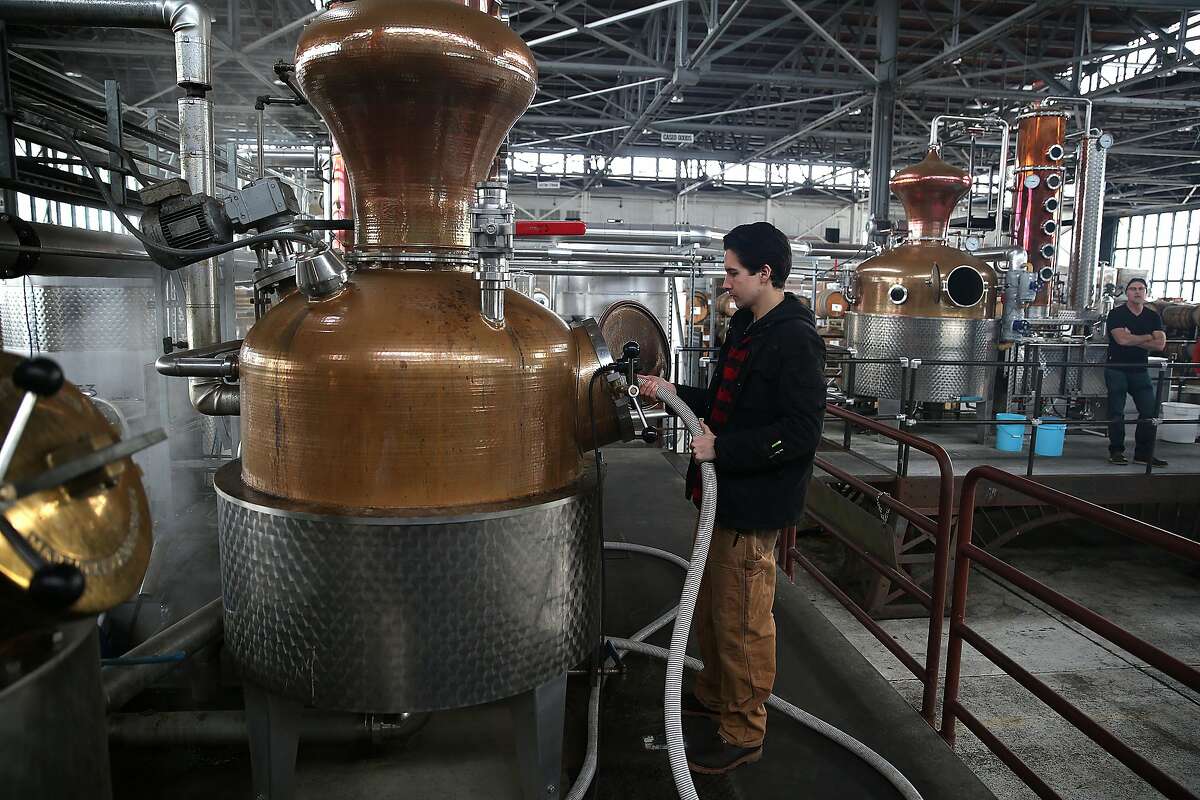 Assistant distiller Christopher Jordan cleans a still at St. George Spirits in Alameda, California, on Thursday, January 28, 2016.