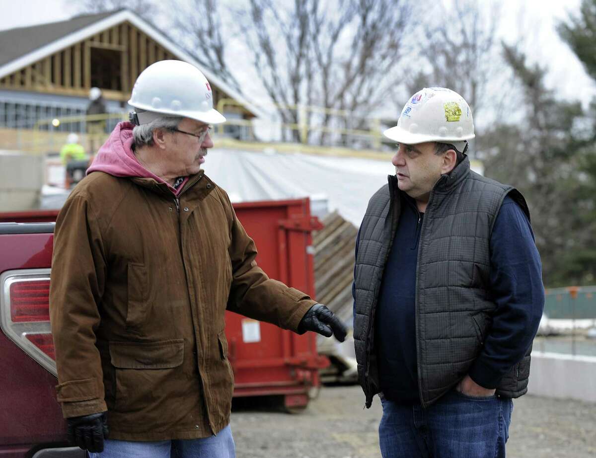 Jon Menti, left, chairman of the public site committee, and John Perna, a committee member, tour the new Bethel Police Station under construction in December. The 26,000-square-foot station is budgeted at $13.5 million but now has cost overruns of nearly $900,000.