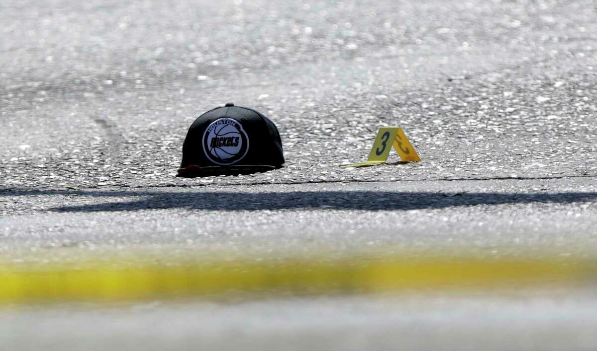 A hat and a marker remain on the road as police investigate the scene of a fatal shooting that involved a police officer on Thursday, March 22, 2018, in Houston. Harris County Sheriff's Deputy Cameron Brewer was fired on April 20, 2018 for allegedly not following the department's use of force procedures in the shooting of Danny Ray Thomas.