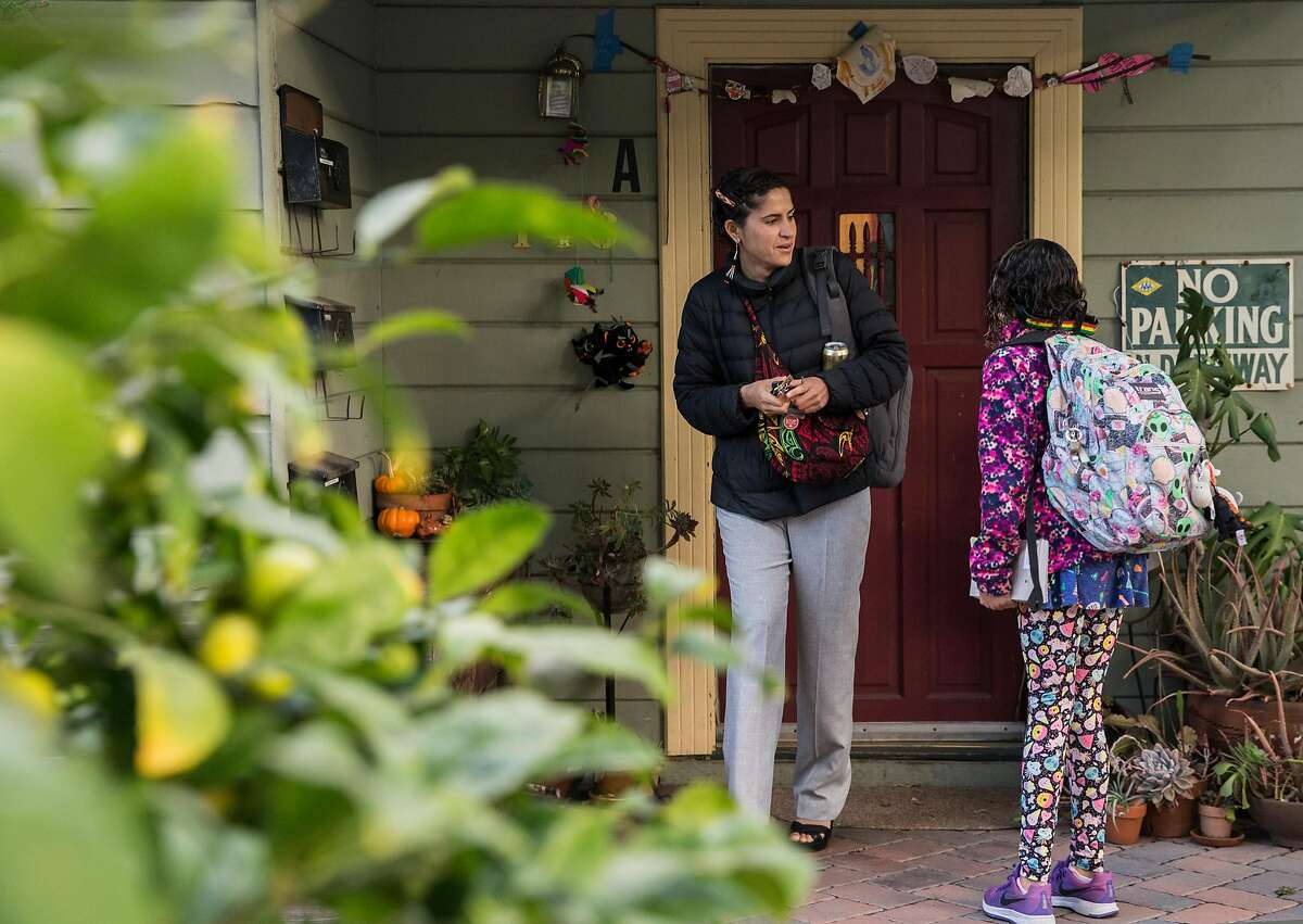 Lorena Melgarejo leaves her home to take her daughter to school Friday, March 23, 2018 in San Francisco, Calif.
