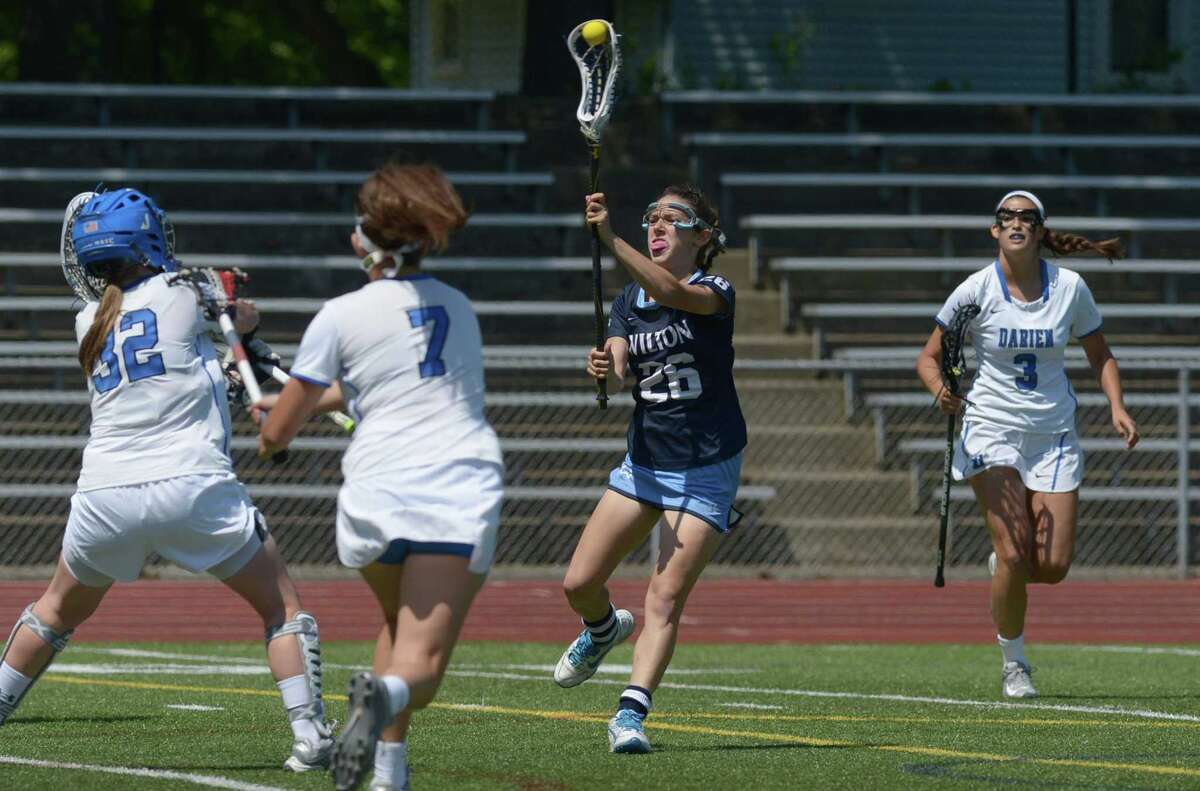Girls Lacrosse Wilton holding a lot of cards